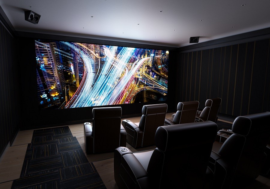 Home theater setup with custom seating and dazzling graphics on the screen.  