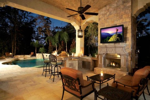 Outdoor area with various light fixtures on the patio, an outdoor TV, and a pool.