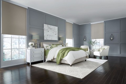 Lutron Sivoia QS half-drawn motorized shades allowing diffuse sunlight into a bedroom.