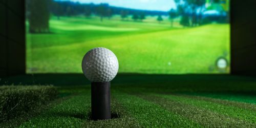 A high-tech golf simulator showing ball tracking and performance metrics on a digital screen.